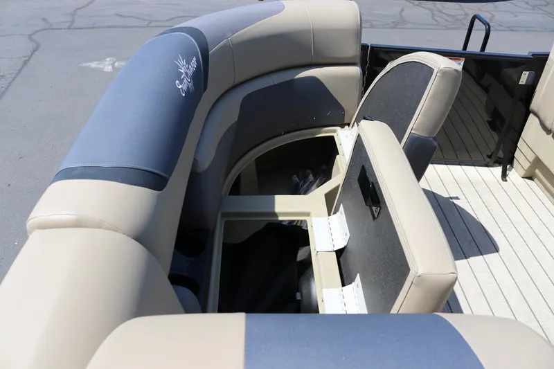 Slide: The Image of 2025 SunChaser Geneva Sport 23 LR PSB boat interior with cushioned seating and storage compartments. - 19