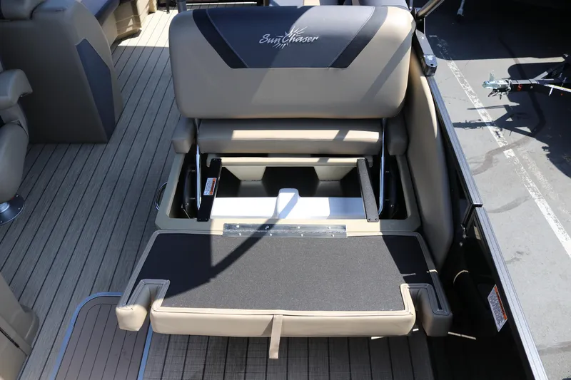 Slide: The Image of SunChaser Geneva Sport 23 LR PSB 2025 boat seat with storage compartment open. - 26