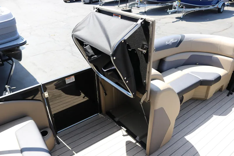 Slide: The Image of 2025 SunChaser Geneva Sport 23 LR PSB pontoon boat interior with seating and storage. - 27