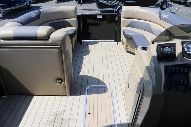 Slide: The Image of Interior of 2025 SunChaser Geneva Sport 23 LR PSB pontoon boat with beige seating and control panel. - 31