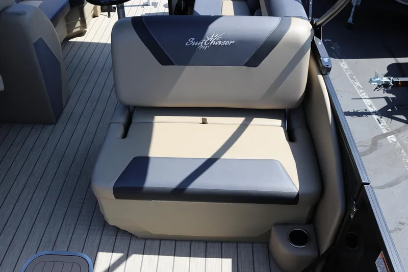 Slide: The Image of SunChaser Geneva Sport 23 LR PSB 2025 boat seating with cup holder on deck. - 35