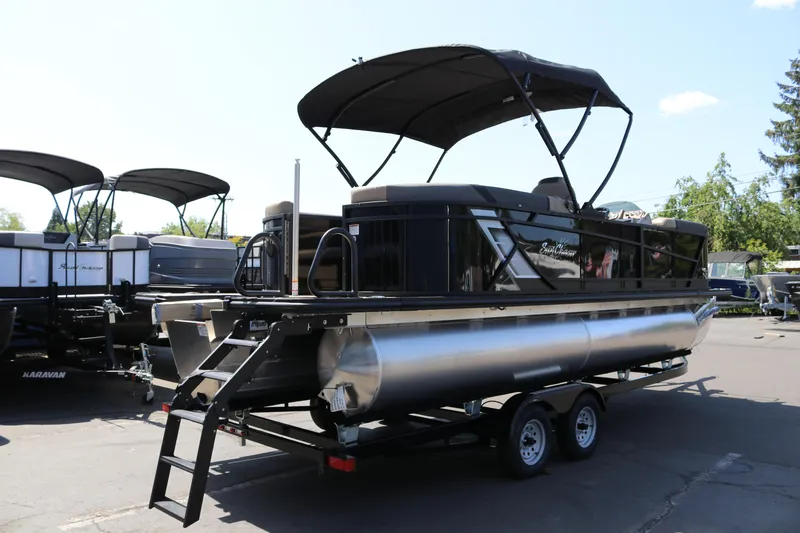 Slide: The Image of 2025 SunChaser Geneva Sport 23 LR PSB pontoon boat on trailer, outdoor display. - 4