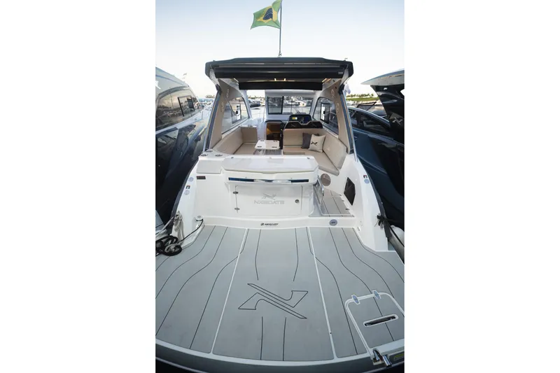 Slide: The Image of 2026 NX Boats NX350 luxury yacht interior with seating and Brazilian flag. - 14