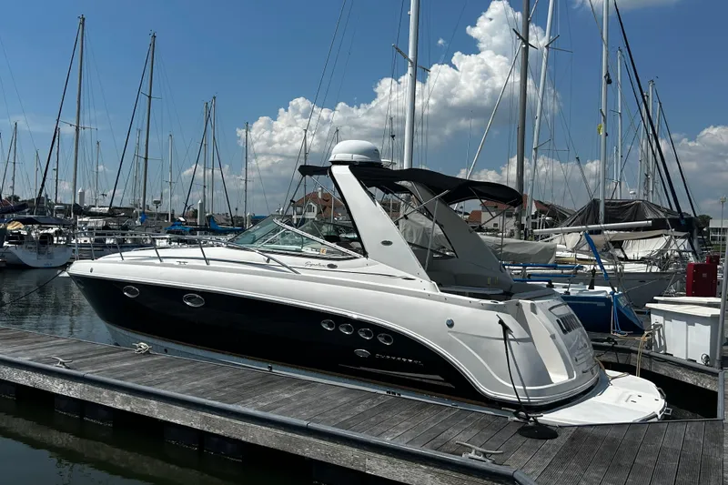 The Image of 2006 Chaparral Signature 350 boat docked at marina under clear blue sky. - 0