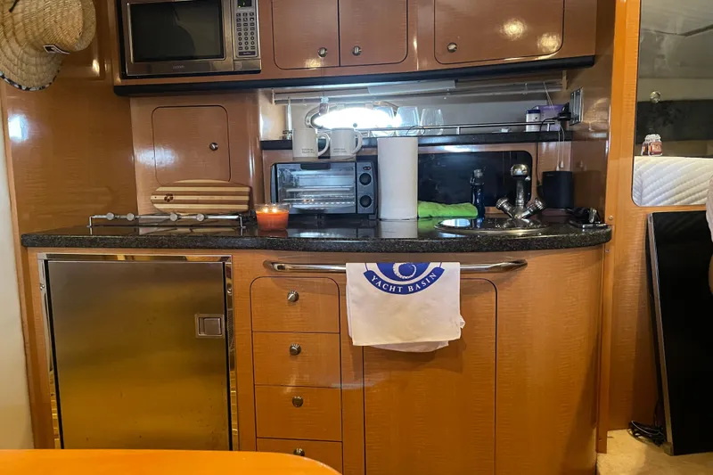 Slide: The Image of Interior of 2006 Chaparral Signature 350 yacht kitchen with appliances and wooden cabinetry. - 11