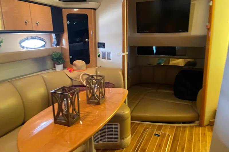Slide: The Image of 2006 Chaparral Signature 350 interior with leather seating, wooden table, and modern decor. - 13