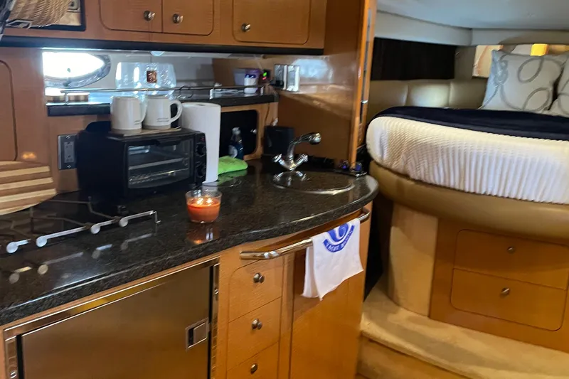Slide: The Image of Interior of 2006 Chaparral Signature 350 yacht with kitchenette and cozy sleeping area. - 15