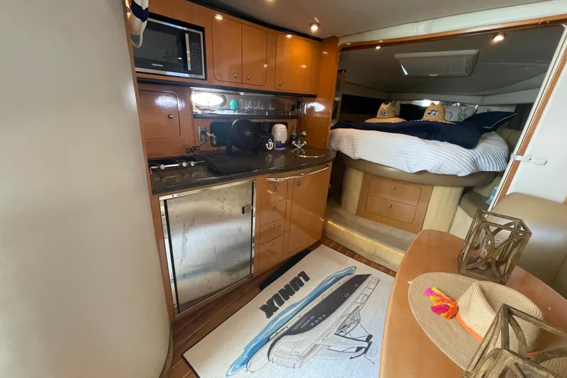 Slide: The Image of Interior of 2006 Chaparral Signature 350 yacht with kitchenette and cozy sleeping area. - 18