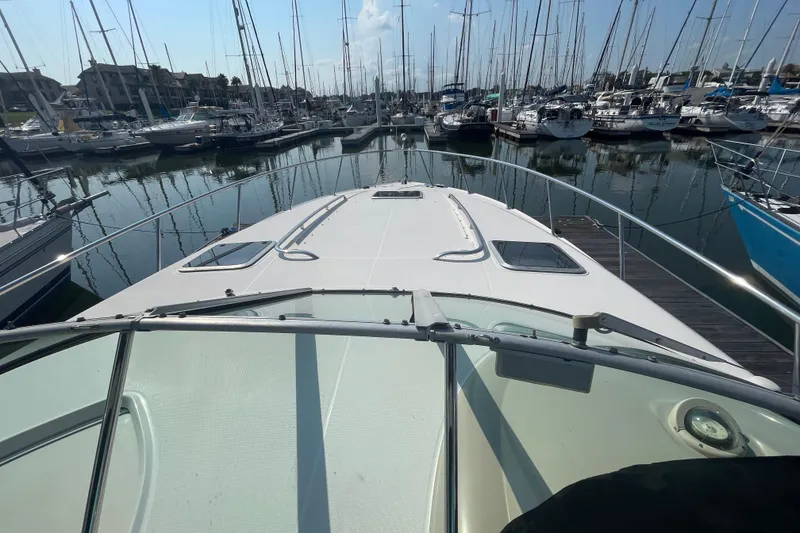 Slide: The Image of 2006 Chaparral Signature 350 yacht docked in a marina with sailboats. - 3
