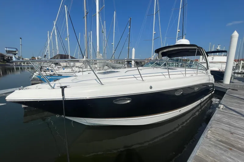 Slide: The Image of 2006 Chaparral Signature 350 docked at marina, sleek design, clear blue sky. - 4