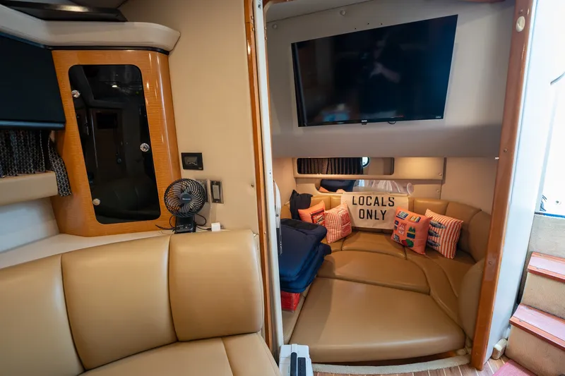 Slide: The Image of Interior of 2006 Chaparral Signature 350 yacht with cozy seating and "Locals Only" pillow. - 16