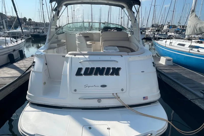 Slide: The Image of 2006 Chaparral Signature 350 boat docked at marina, rear view with "LUNIX" name. - 6