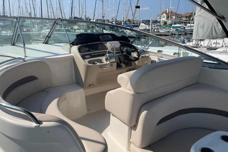 Slide: The Image of 2006 Chaparral Signature 350 boat interior with helm and seating, docked at marina. - 7