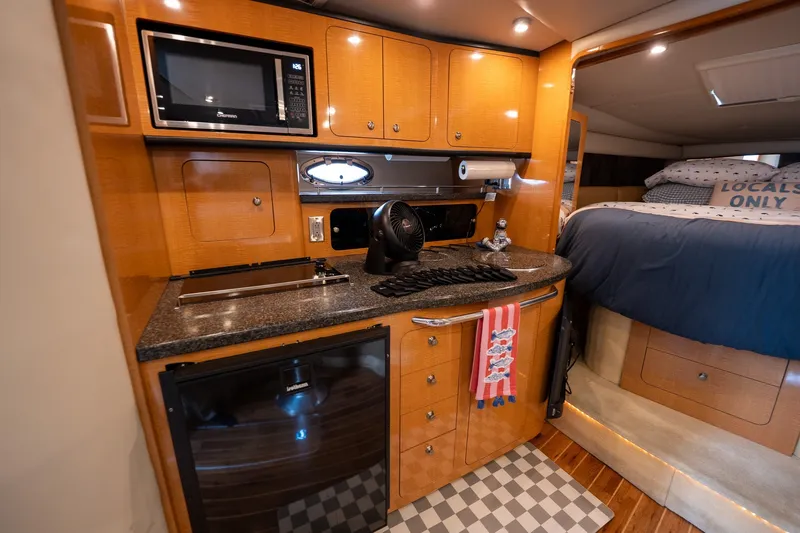Slide: The Image of 2006 Chaparral Signature 350 yacht interior with kitchenette and cozy sleeping area. - 12