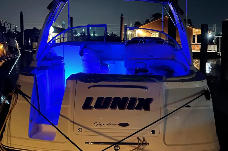 Slide: The Image of 2006 Chaparral Signature 350 boat with blue interior lighting at night. - 9