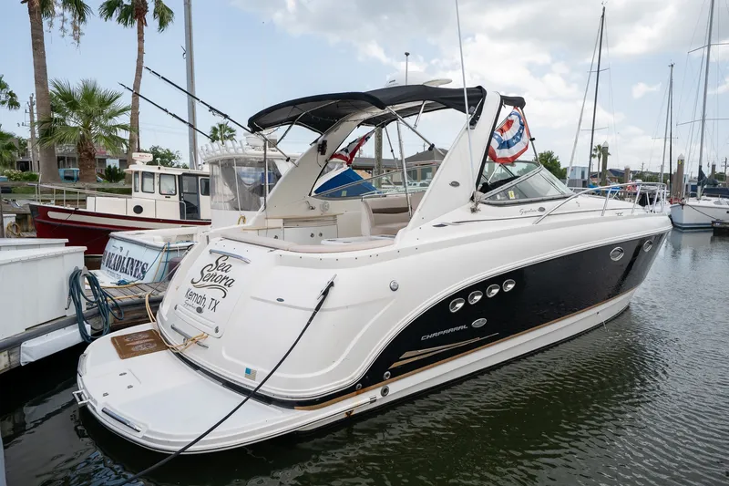 Slide: The Image of 2006 Chaparral Signature 350 boat docked in marina, featuring sleek design and elegant detailing. - 0