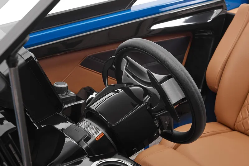Slide: The Image of Manufacturer Provided Image: 2026 Yamaha Boats 255XD interior, featuring sleek steering wheel and luxurious tan seating. - 12
