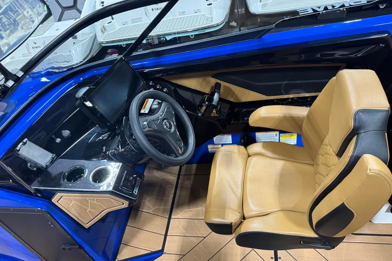 Slide: The Image of 2026 Yamaha Boats 255XD cockpit with tan seating, modern steering, and digital display. - 4