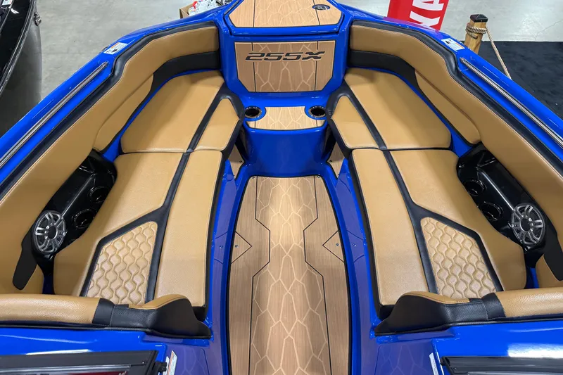 Slide: The Image of 2026 Yamaha Boats 255XD interior with tan seating and blue accents. - 7