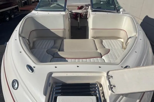 Slide: The Image of 2006 Bryant 219 boat interior with white seating and open storage compartment. - 10
