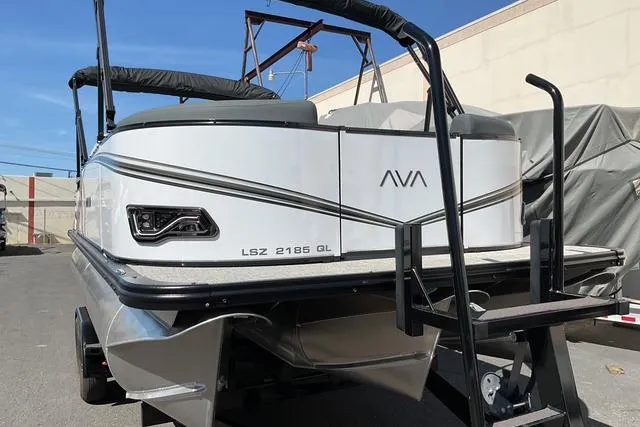 Slide: The Image of 2025 Avalon LSZ QUAD LOUNGE pontoon boat, rear view, parked outdoors. - 1