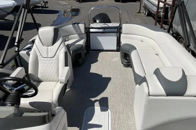 Slide: The Image of 2025 Avalon LSZ Quad Lounge pontoon boat interior with luxurious seating and modern design. - 12