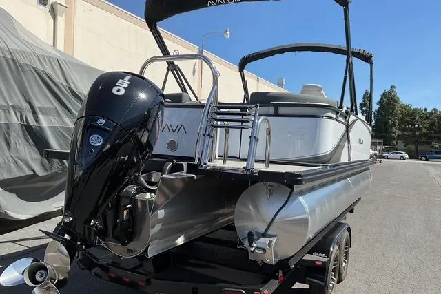 Slide: The Image of 2025 Avalon LSZ Quad Lounge pontoon boat with powerful outboard motor on trailer. - 3