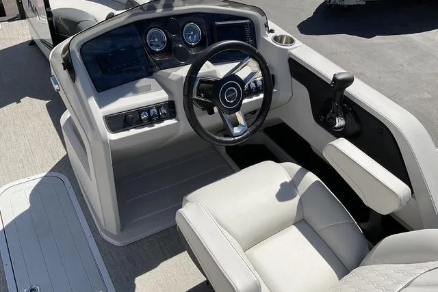 Slide: The Image of 2025 Avalon LSZ QUAD LOUNGE boat interior with steering wheel and control panel. - 9
