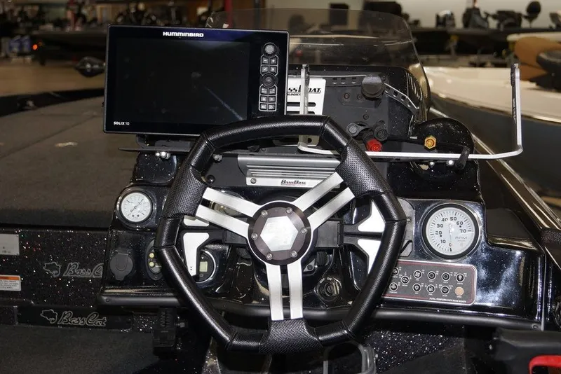 Slide: The Image of Dashboard of a 2020 Bass Cat Lynx boat with steering wheel and Humminbird electronics. - 11