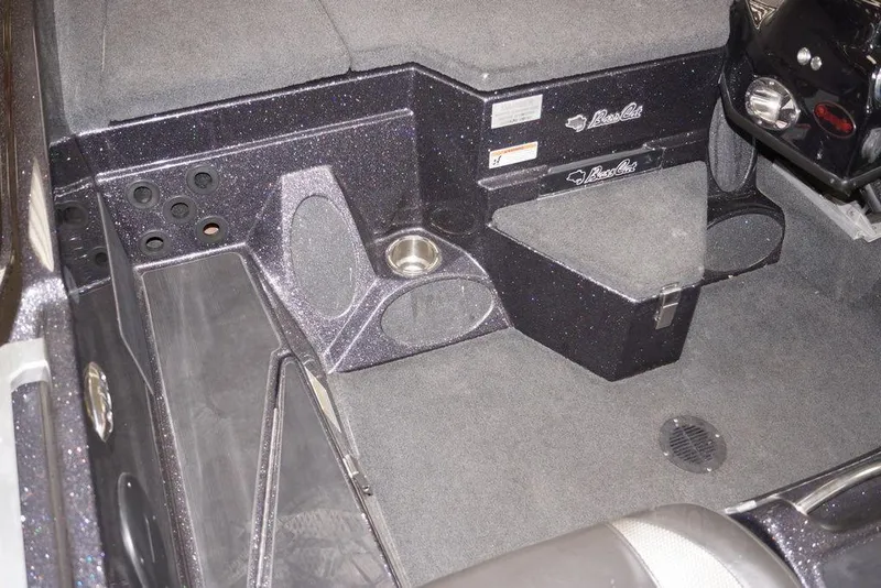 Slide: The Image of 2020 Bass Cat Lynx boat interior with carpeted flooring and storage compartments. - 17