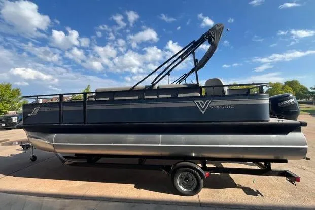 Slide: The Image of 2023 Viaggio Del Mar D20F pontoon boat on trailer under a clear blue sky. - 2