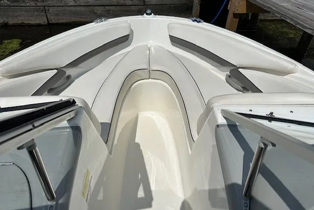 Slide: The Image of 2011 Bayliner 185 boat interior with white seating and open bow design. - 2