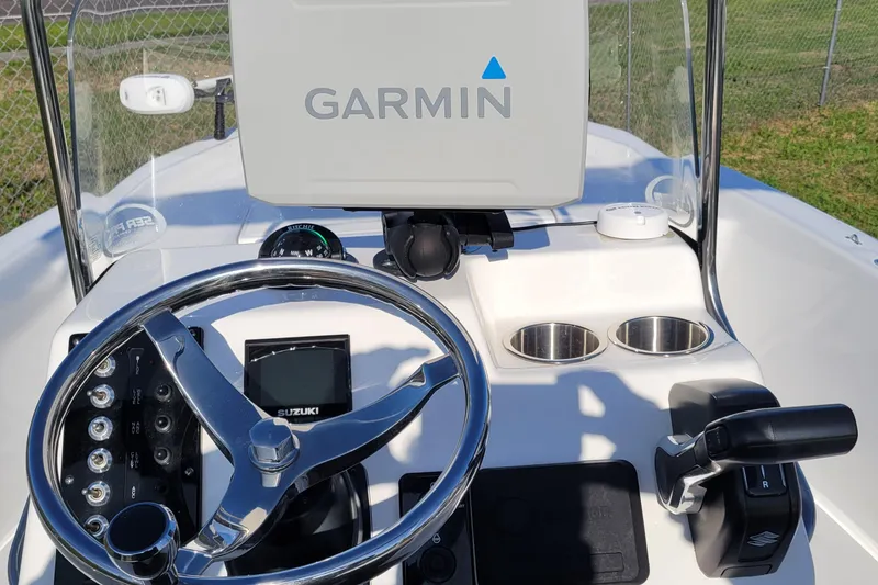 Slide: The Image of 2024 Sea Pro 172 Bay boat dashboard with Garmin display and Suzuki controls. - 3