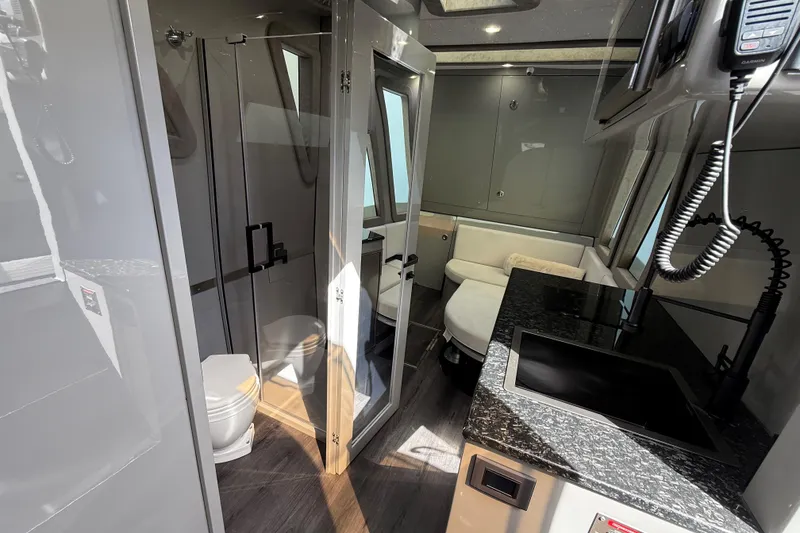 Slide: The Image of Helm of 2025 Midnight Express 52 Vitesse with advanced navigation displays and controls. - 10