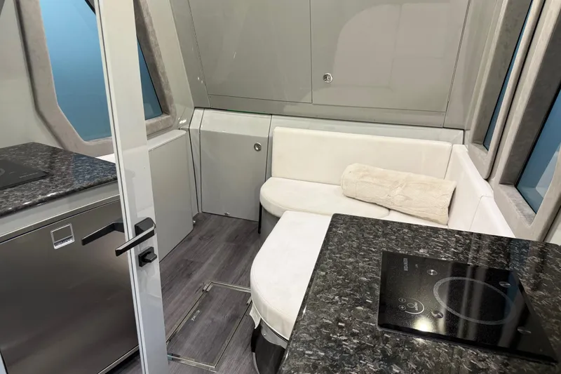 Slide: The Image of Luxurious interior of 2025 Midnight Express 52 Vitesse yacht with modern seating and kitchenette. - 17
