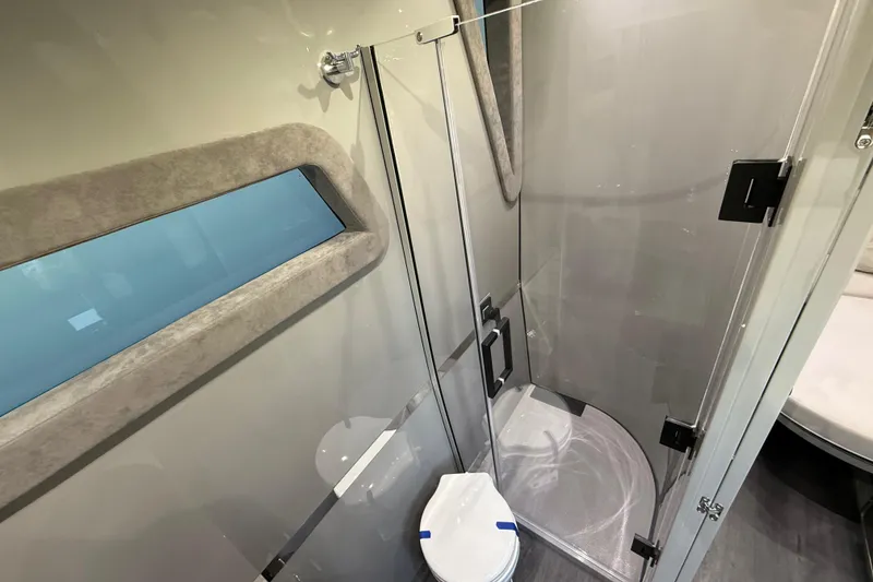Slide: The Image of Luxurious bathroom in 2025 Midnight Express 52 Vitesse yacht with modern shower and window. - 19