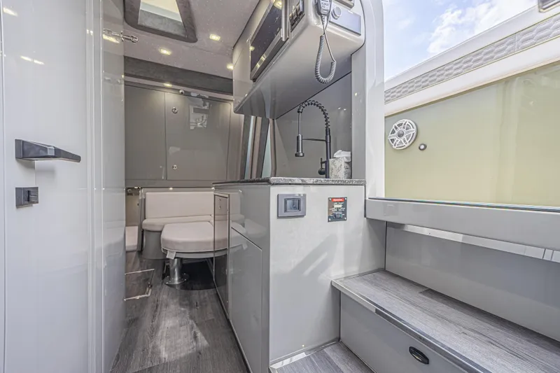 Slide: The Image of Luxurious interior of 2025 Midnight Express 52 Vitesse yacht with modern kitchen and seating area. - 28