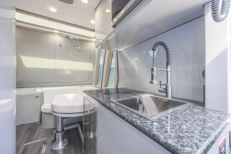 Slide: The Image of Luxurious interior of 2025 Midnight Express 52 Vitesse yacht with modern kitchen and seating area. - 29