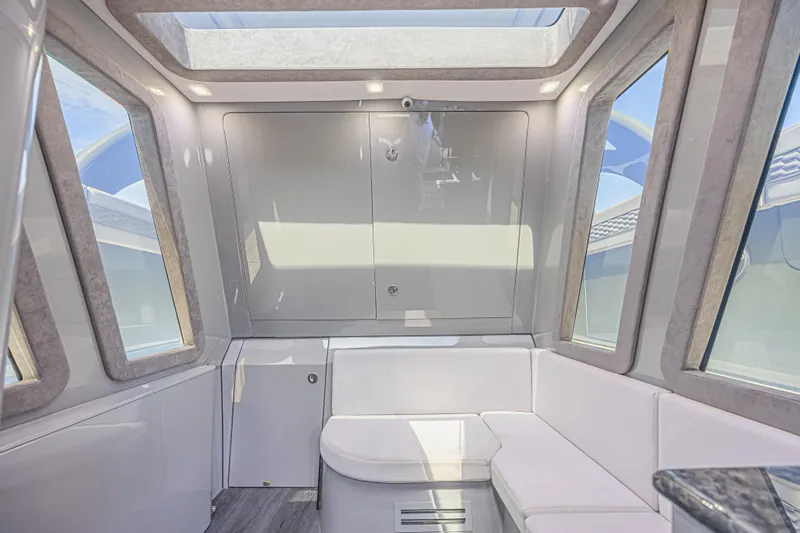 Slide: The Image of Luxurious interior of 2025 Midnight Express 52 Vitesse yacht with modern seating and skylight. - 31