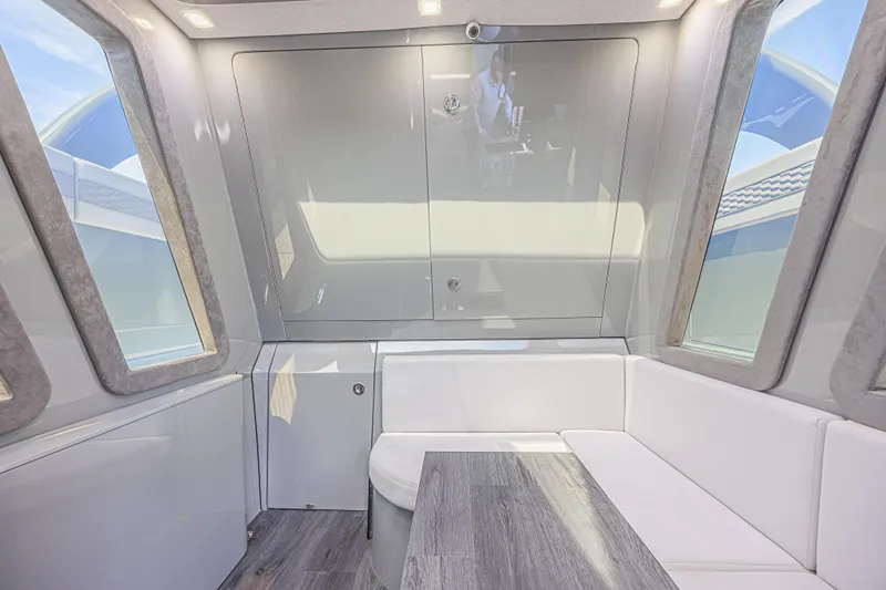 Slide: The Image of Luxurious interior of 2025 Midnight Express 52 Vitesse yacht with modern seating and windows. - 32
