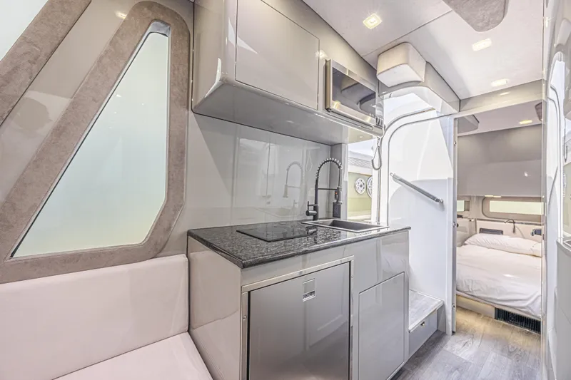 Slide: The Image of Luxurious interior of 2025 Midnight Express 52 Vitesse yacht with modern kitchen and cozy bedroom. - 39