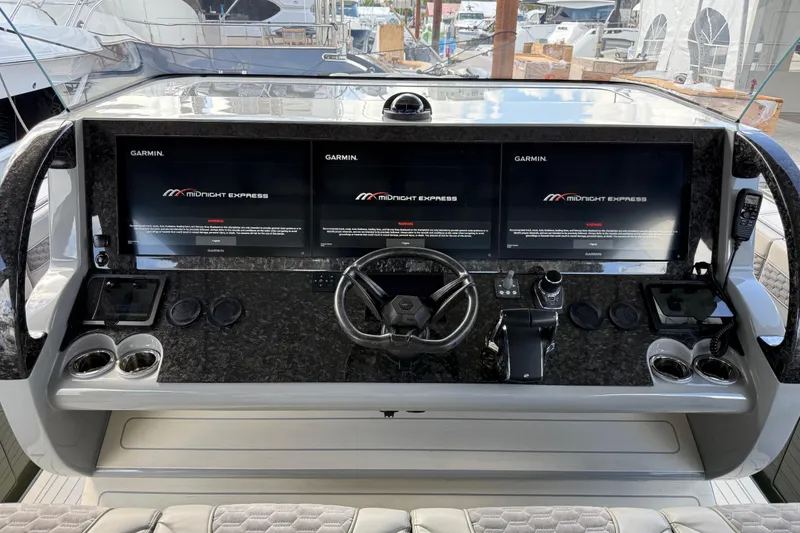 Slide: The Image of Luxurious seating on 2025 Midnight Express 52 Vitesse yacht at marina. - 7