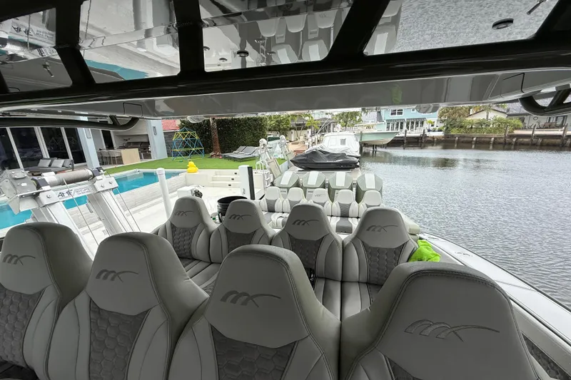 Slide: The Image of Interior of 2025 Midnight Express 52 Vitesse yacht with luxury seating and entertainment system. - 8