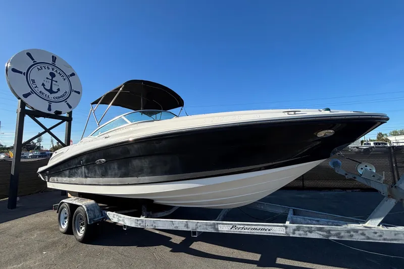 The Image of 2007 Sea Ray SLX 250 boat on trailer under clear blue sky. - 0