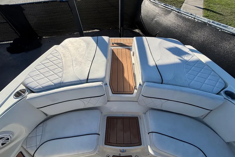 Slide: The Image of 2007 Sea Ray SLX 250 boat on trailer, viewed from the front under clear blue sky. - 10