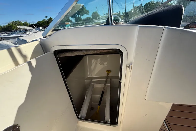 Slide: The Image of 2007 Sea Ray SLX 250 boat with spacious deck and seating, docked at marina. - 12