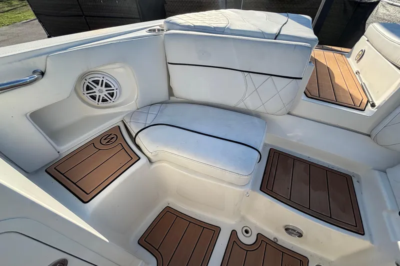 Slide: The Image of 2007 Sea Ray SLX 250 boat with spacious deck and seating, displayed outdoors. - 13