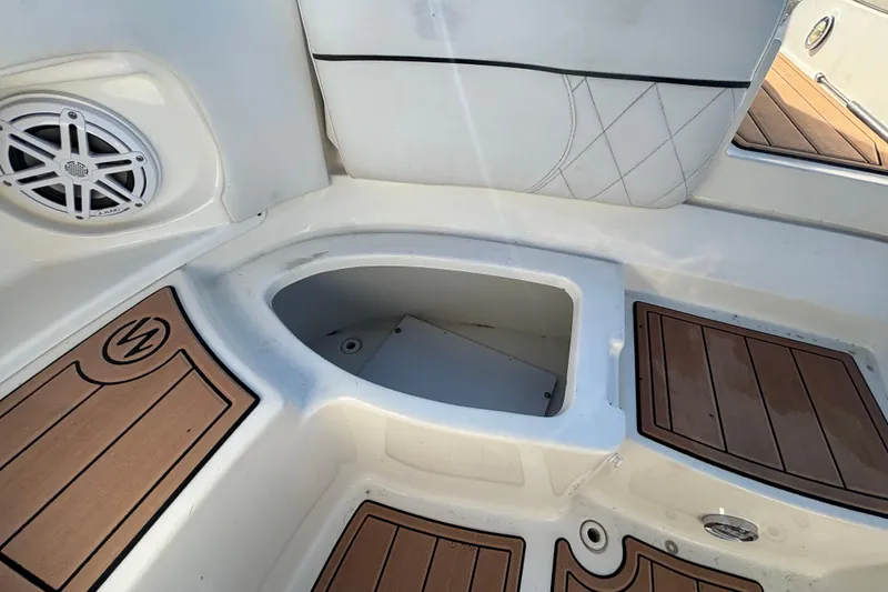 Slide: The Image of 2007 Sea Ray SLX 250 boat interior with seating, steering wheel, and wood flooring. - 14