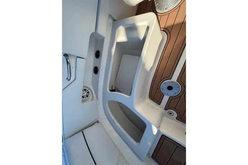 Slide: The Image of 2007 Sea Ray SLX 250 boat interior with dual seats and wooden flooring. - 16