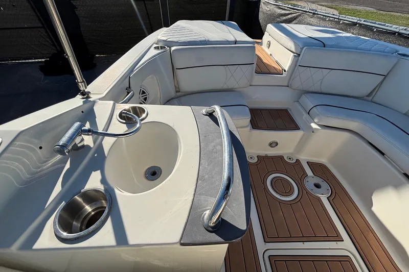 Slide: The Image of 2007 Sea Ray SLX 250 boat interior with white seating and round table. - 19